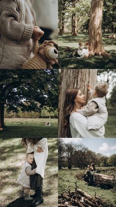 a woman holding a baby in her arms while standing next to a tree with logs