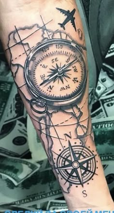 a man with a compass tattoo on his arm