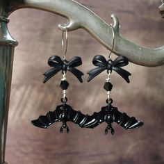 Gorgeously gothic black bat earrings for the times when you need to embrace your darker side!  1"  The bats are just over 1.5 inches across and hang below pretty black bows. The earwires are hypoallergenic stainless steel but can be swapped for silverplated clip on earrings if needed, just choose that option from the drop down menu. The earrings are just over 2.5 inches long and would be the perfect finishing touch to your gothic or dark cottagecore style outfit! As you can see in the final phot Gothic Cottagecore Fashion, Dark Cottagecore Jewelry, Goth Piercings, Cottagecore Jewelry, Goth Accessories, Goth Earrings, Earrings Aesthetic, Bat Earrings, Cottagecore Style