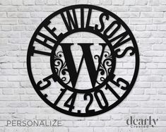 personalized metal wall art with the letter w in black on a white brick wall