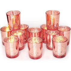 a group of pink glass cups sitting next to each other