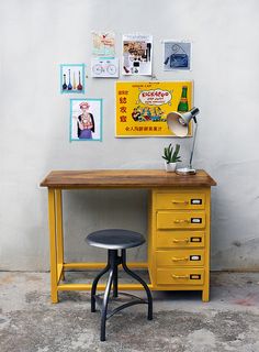 a yellow desk with a guitar on it