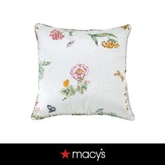 a white pillow with flowers on it and the words macy's written in red