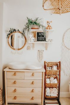 a baby's room with a crib, dresser and mirror