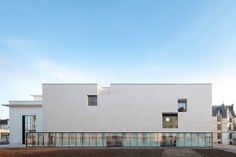 a white building with lots of windows on top of it