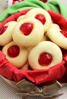 some cookies with jelly on them in a red bowl