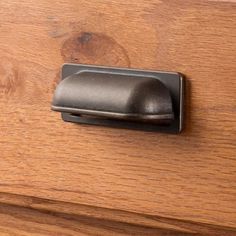 a close up of a drawer handle on a wooden dresser