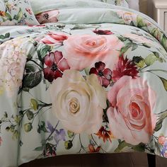 an image of a bed with floral comforter and pillow set on it's side