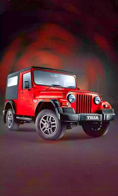 a red jeep parked in front of a black background