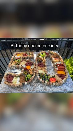 a table topped with lots of food on top of a stone slab covered in cheese