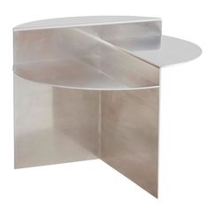 the corner table is made out of metal and has a circular base with a white top