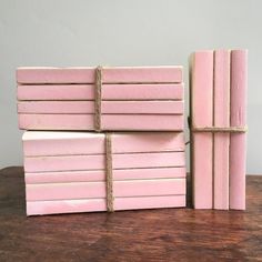 four pink books stacked on top of each other