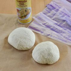 two uncooked buns sitting on top of a table