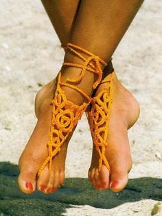 a woman's feet with yellow laces on them