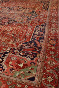 This antique Persian Serapi rug, dating back to circa 1900, showcases a classic tribal style with intricate design elements. Originating from the northwest mountainous regions of Persia, Serapi rugs are well-regarded for their distinct aesthetic and craftsmanship. The primary background color of this rug is a rich rust, which is complemented by a navy border. The main field predominantly features a deep red hue. The rug's wool pile is woven onto a cotton foundation, typical of traditional Persia Persian Rug Designs, Rug Designs, Serapi Rug, Transitional Rugs, Red Rug, Intricate Design, Red Rugs, Red Background, Deep Red