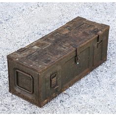 an old metal box sitting on the ground