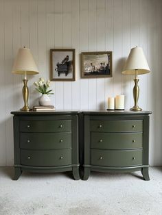 two green dressers with lamps and pictures on the wall