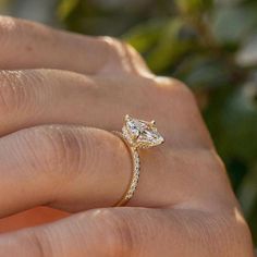 a woman's hand with a diamond ring on it