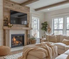 a living room filled with furniture and a flat screen tv mounted above a fire place