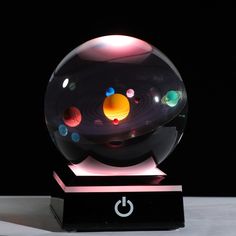 a glass ball with different colored planets in it