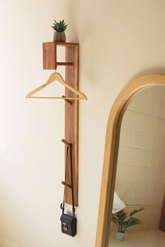 a mirror and coat rack on the wall