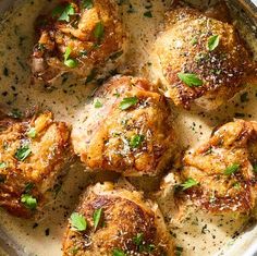 chicken thighs with parmesan cheese and herbs in a pan