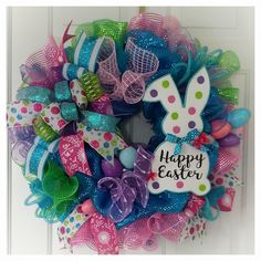 a colorful easter wreath with the words happy easter on it