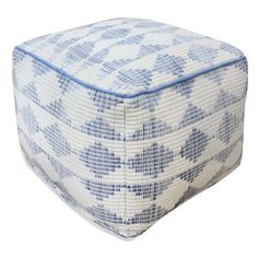 a blue and white square ottoman cushion on a white background, with an abstract pattern