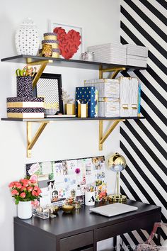 a black desk with gold shelves and pictures on the wall above it is an instagram page for pinterest