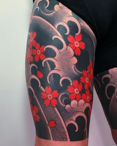 a woman with red flowers on her thigh and arm tattoo design in black and grey