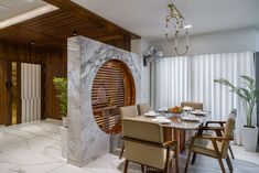 an elegant dining room with marble and wood accents