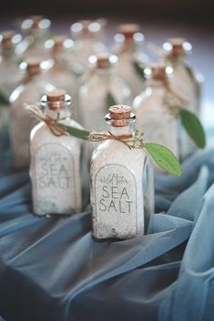 several small bottles with sea salt in them