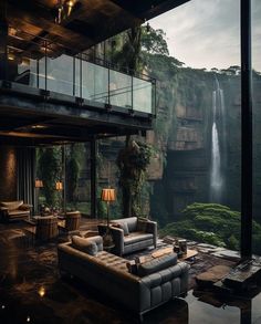 a living room filled with furniture next to a waterfall