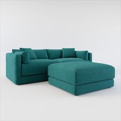 a blue couch and ottoman sitting next to each other on a white surface with no one in it