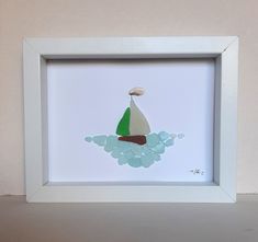 a white frame with a painting of a sailboat on it