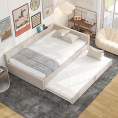 a white bed sitting on top of a wooden floor