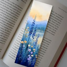 an open book with watercolors and flowers on it