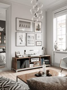 a living room filled with furniture and pictures on the wall