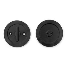 two black round knobs on a white background with one button facing the other direction