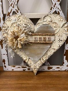 a heart shaped frame with the word love written on it