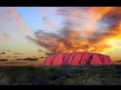 the sun is setting over ulururu rock in australia's outback region