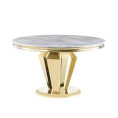 a round table with a marble top and gold legs