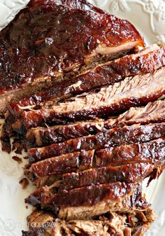 sliced barbecue ribs on a white plate