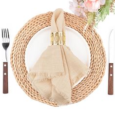 a place setting with napkins, silverware and flowers