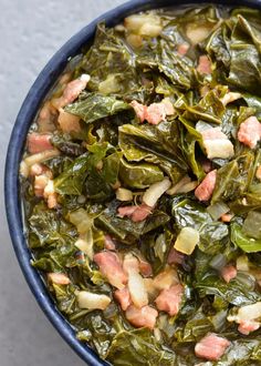 collard greens with ham and onions in a blue bowl