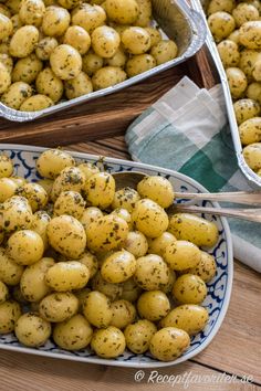 there are several tins filled with potatoes on the table and one has a spoon in it