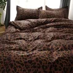 an image of a bed with leopard print sheets and pillowcases on the cover