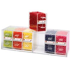 three clear acrylic bins filled with different colored candies