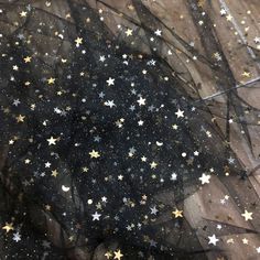 black and gold stars on sheer fabric with white dots in the center, as seen from above