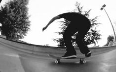 a man riding a skateboard up the side of a ramp